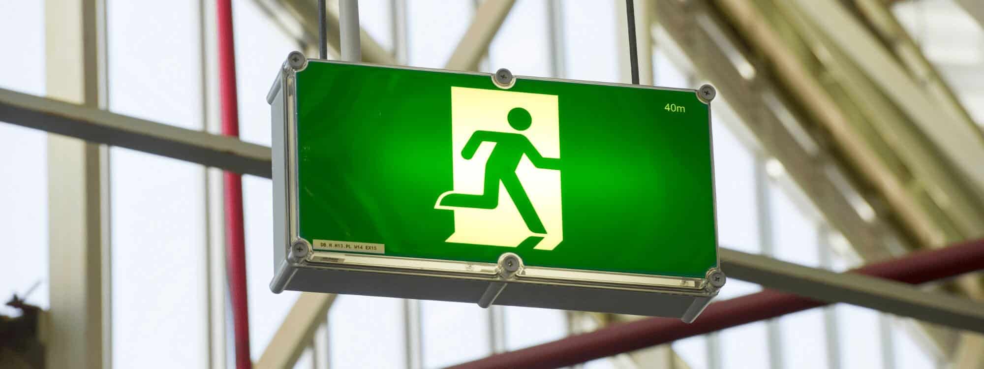 A working emergency exit sign highlights the importance of Increasing emergency capabilities and preparedness within organisations